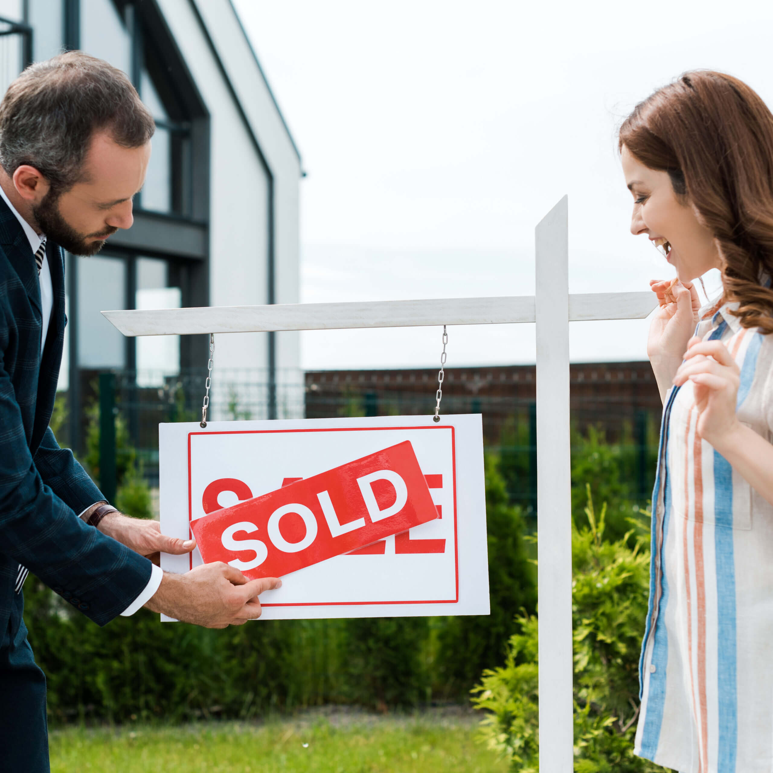 attractive woman looking at board sold scaled